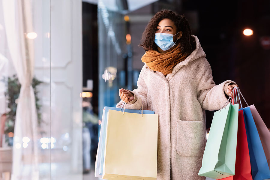 woman in mall with shopping bags