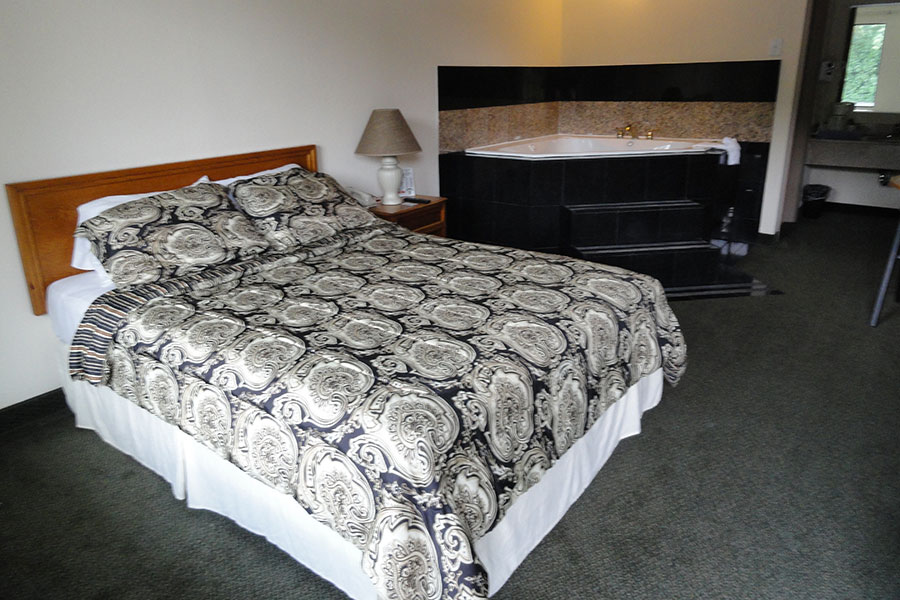 guest suite with one king bed and jetted tub